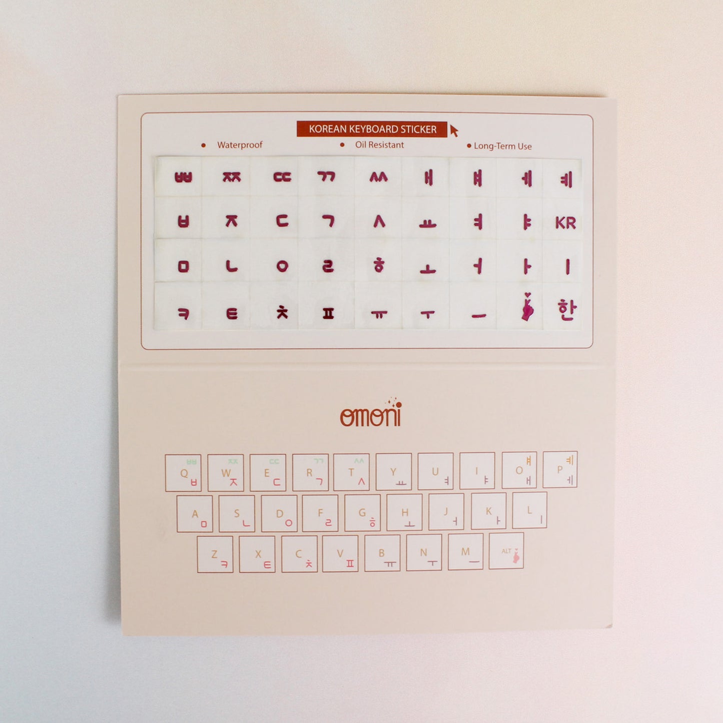 An image showing a laptop keyboard packaging showcasing the Korean seamless die-cut sticker set. Seamless die-cut Korean Hangul keyboard sticker with Korean alphabet letters for learning Korean, typing practice, vocabulary building and beginner Korean language lessons. Keyboard Sticker Metallic Pink Color.