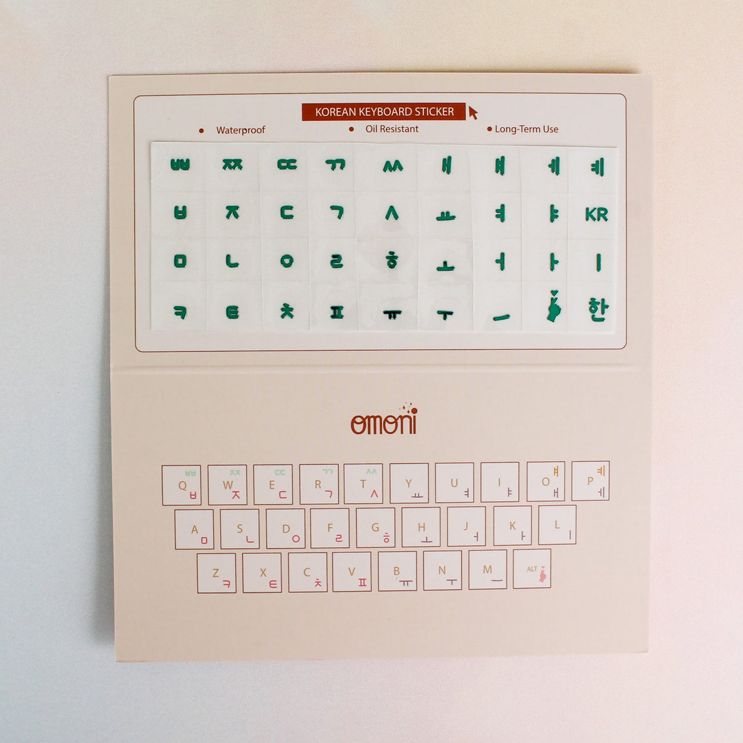 An image showing a laptop keyboard packaging showcasing the Korean seamless die-cut sticker set. Seamless die-cut Korean Hangul keyboard sticker with Korean alphabet letters for learning Korean, typing practice, vocabulary building and beginner Korean language lessons. Keyboard Sticker Metallic Green Color.