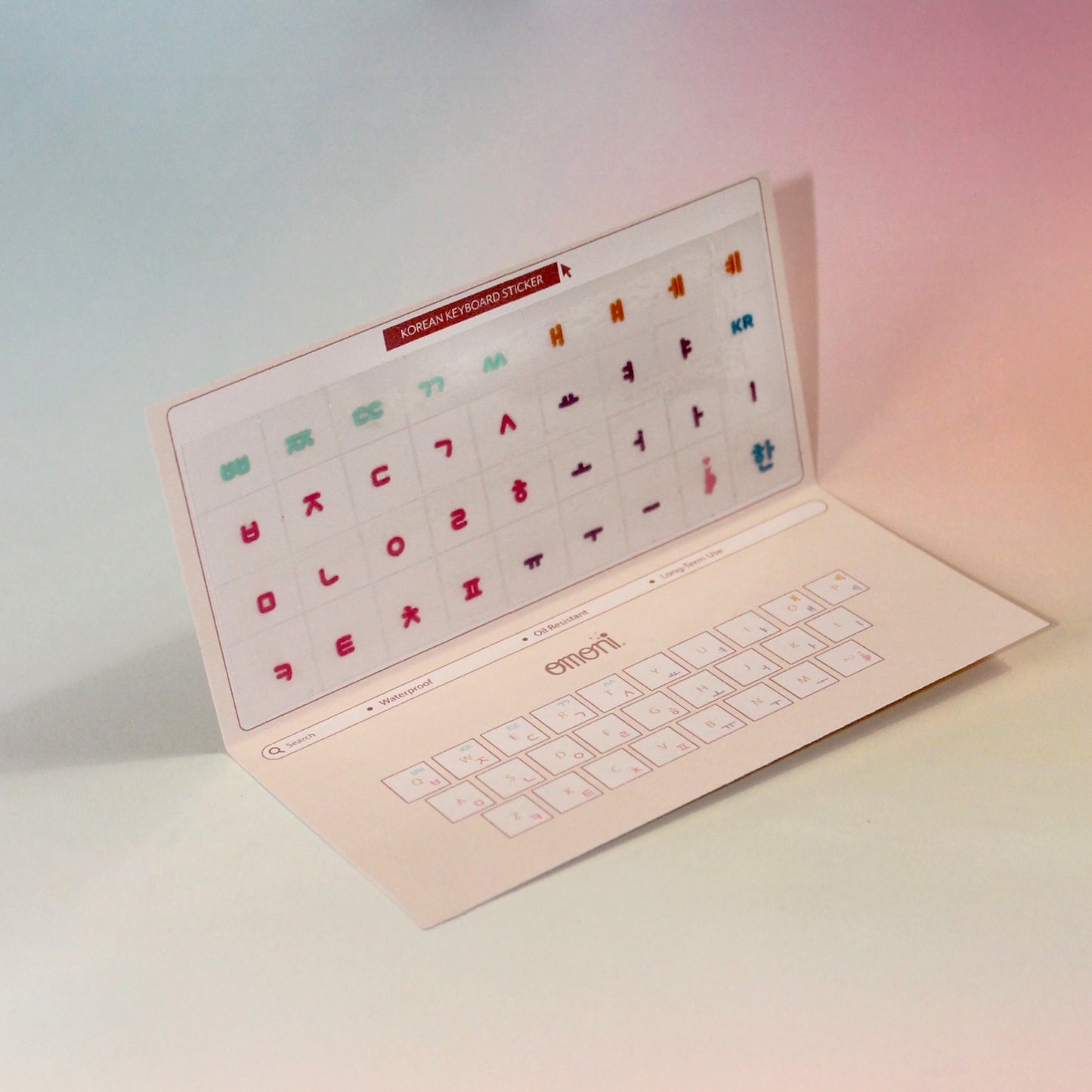 A angled image showing a laptop keyboard packaging showcasing the Korean seamless die-cut sticker set. Seamless die-cut Korean Hangul keyboard sticker with Korean alphabet letters for learning Korean, typing practice, vocabulary building and beginner Korean language lessons. Keyboard Sticker Multicolor Color.