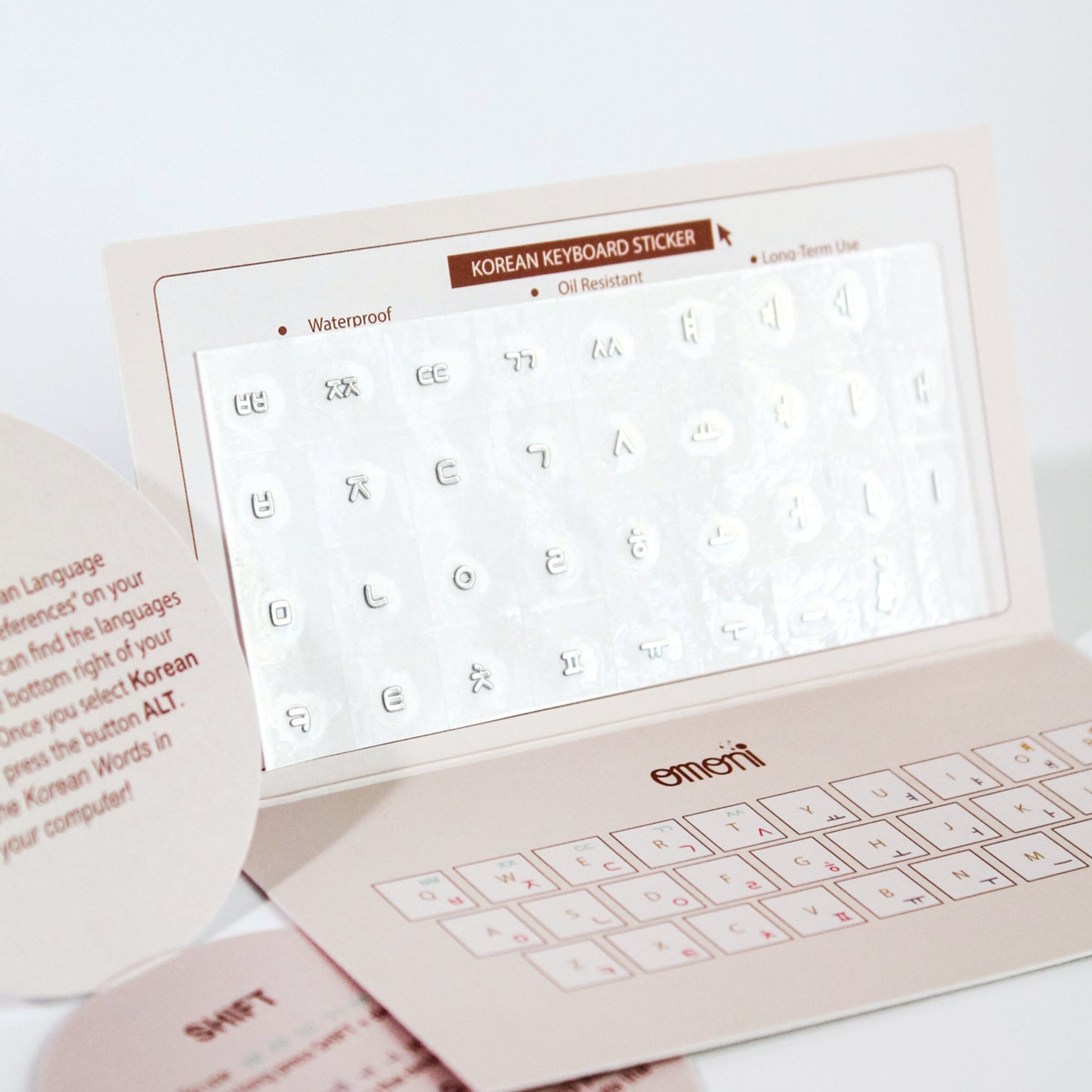 A image showing a laptop keyboard packaging showcasing the Korean seamless die-cut sticker set. Seamless die-cut Korean Hangul keyboard sticker with Korean alphabet letters for learning Korean, typing practice, vocabulary building and beginner Korean language lessons. Keyboard Sticker Metallic Silver Color.